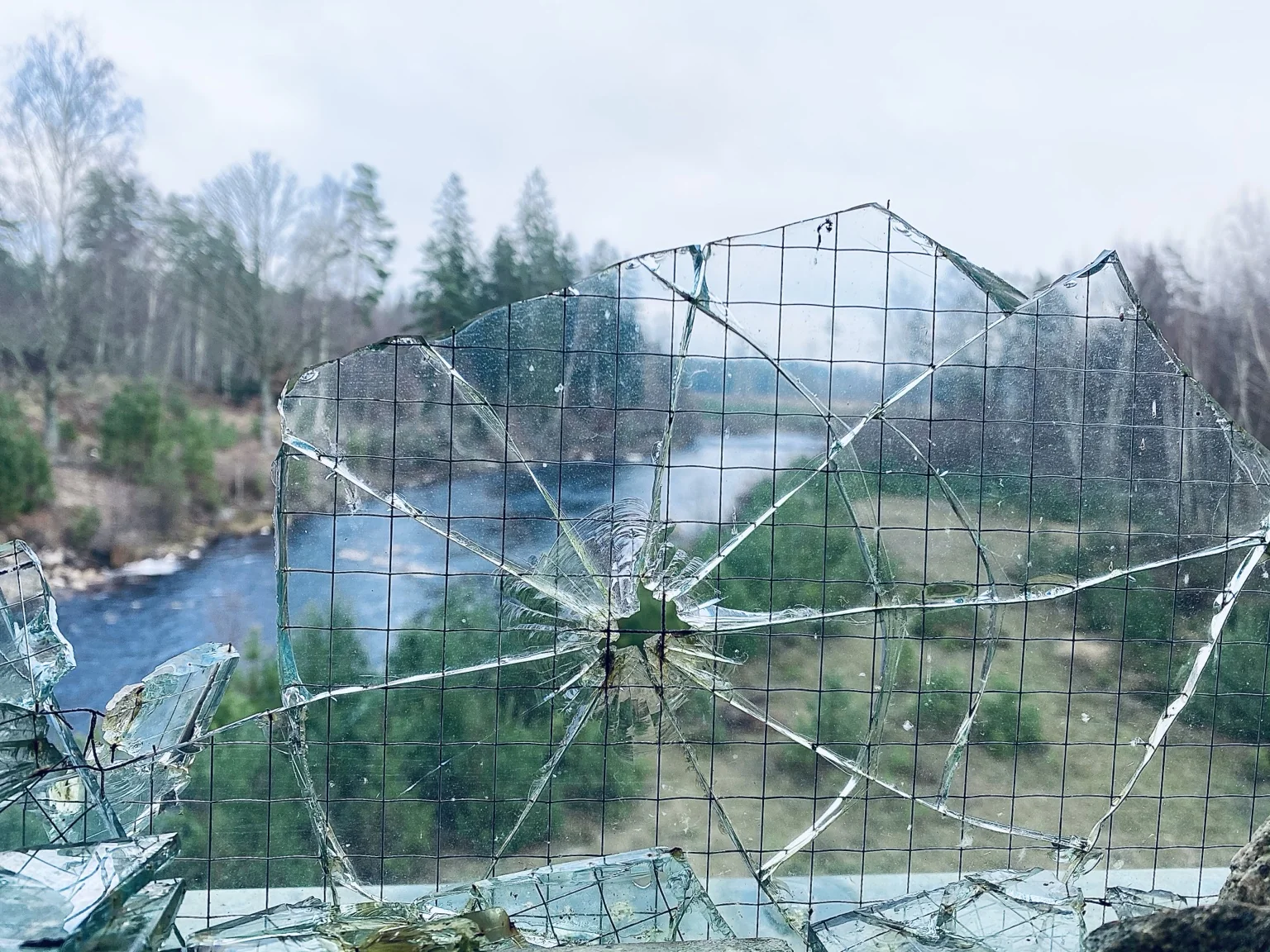 Broken glass with landscape beyond